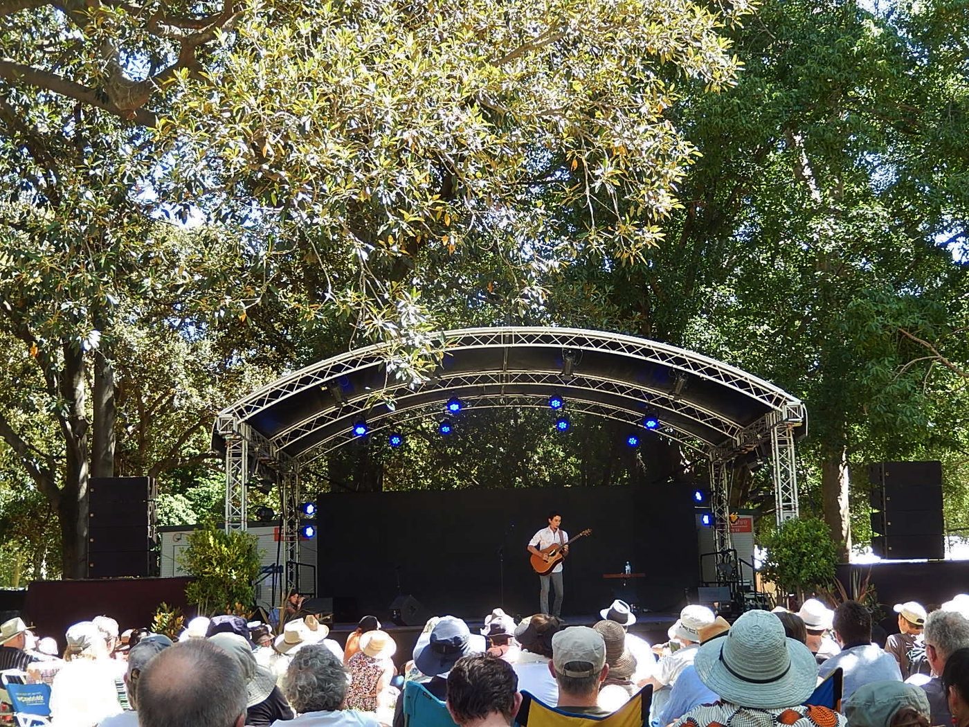 Makana performing with guitar on the Moreton Bay Stage at WOMADelaide